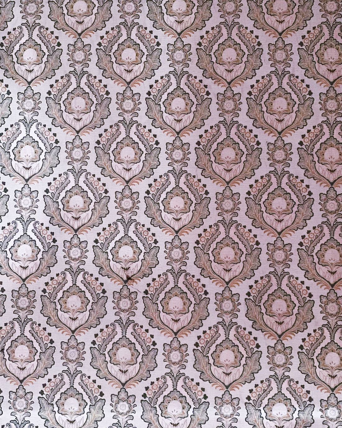 Close-up of a mauve and cream damask wallpaper pattern